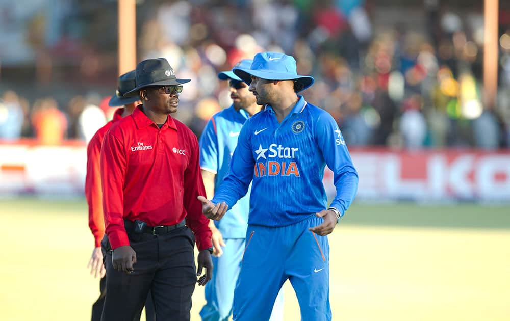 Indian bowler Harbhajan Singh, right, talks to the umpire after the match on the second day of the One Day International cricket match against Zimbabwe in Harare, Zimbabwe.