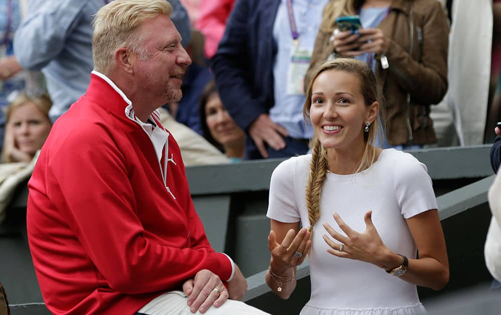 Jelena, wife of Novak Djokovic of Serbia, and his coach Boris Becker, celebrate after Djokovic won the men's singles final against Roger Federer of Switzerland at the All England Lawn Tennis Championships in Wimbledon.