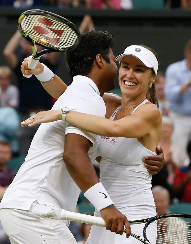 Leander Paes of India, left, and Martina Hingis of Switzerland celebrate winning the mixed doubles final against Alexander Peya of Austria and Timea Babos of Hungary at the All England Lawn Tennis Championships in Wimbledon, London.