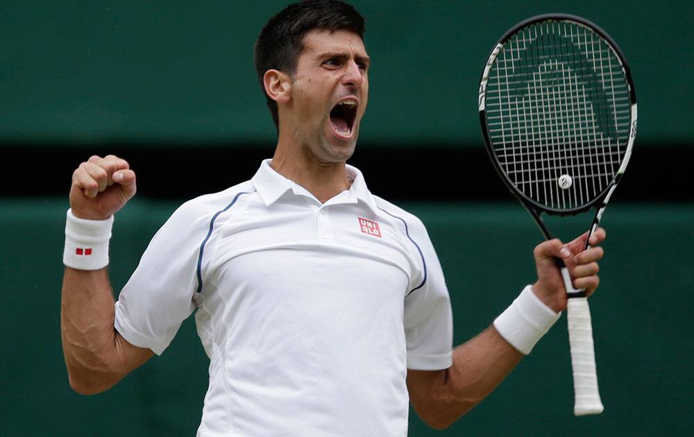 Novak Djokovic of Serbia celebrates winning the men's singles final against Roger Federer of Switzerland at the All England Lawn Tennis Championships in Wimbledon, London.