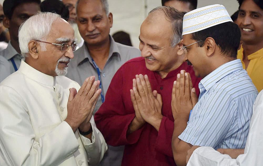 Delhi Chief Minister Arvind Kejriwal accompained by Deputy Chief Minister Manish Sisodia welcomes Vice President Hamid Ansari during an Iftar party hosted by him in New Delhi.