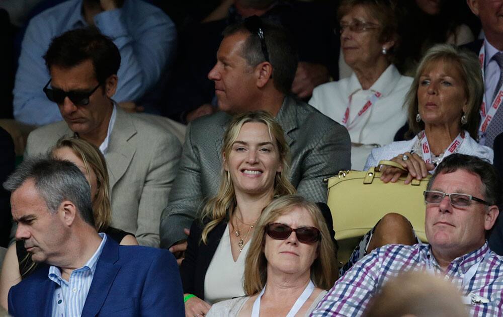 British actress Kate Winslet, centre, watches the men's singles final between Novak Djokovic of Serbia and Roger Federer of Switzerland at the All England Lawn Tennis Championships in Wimbledon, London.