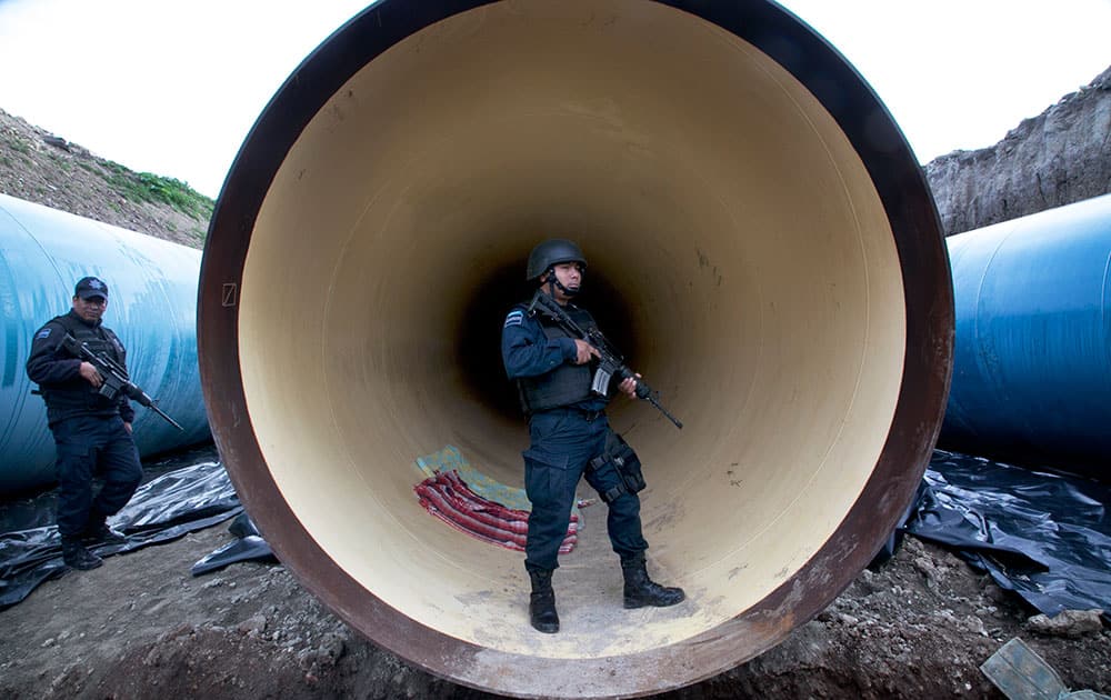 Federal police guard a drainage pipe outside of the Altiplano maximum security prison in Almoloya, west of Mexico City.