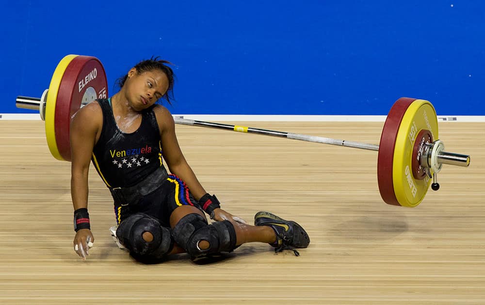 Venezuela's Genesis Rodriguez Gomez collapses during a lift attempt in the women's 53kg weightlifting at the Pan Am Games in Oshawa, Ontario.