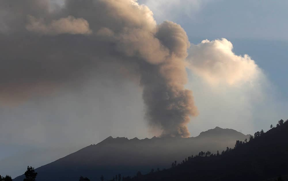 Mount Raung spews volcanic materials into the air as seen from Melaten, East Java, Indonesia.