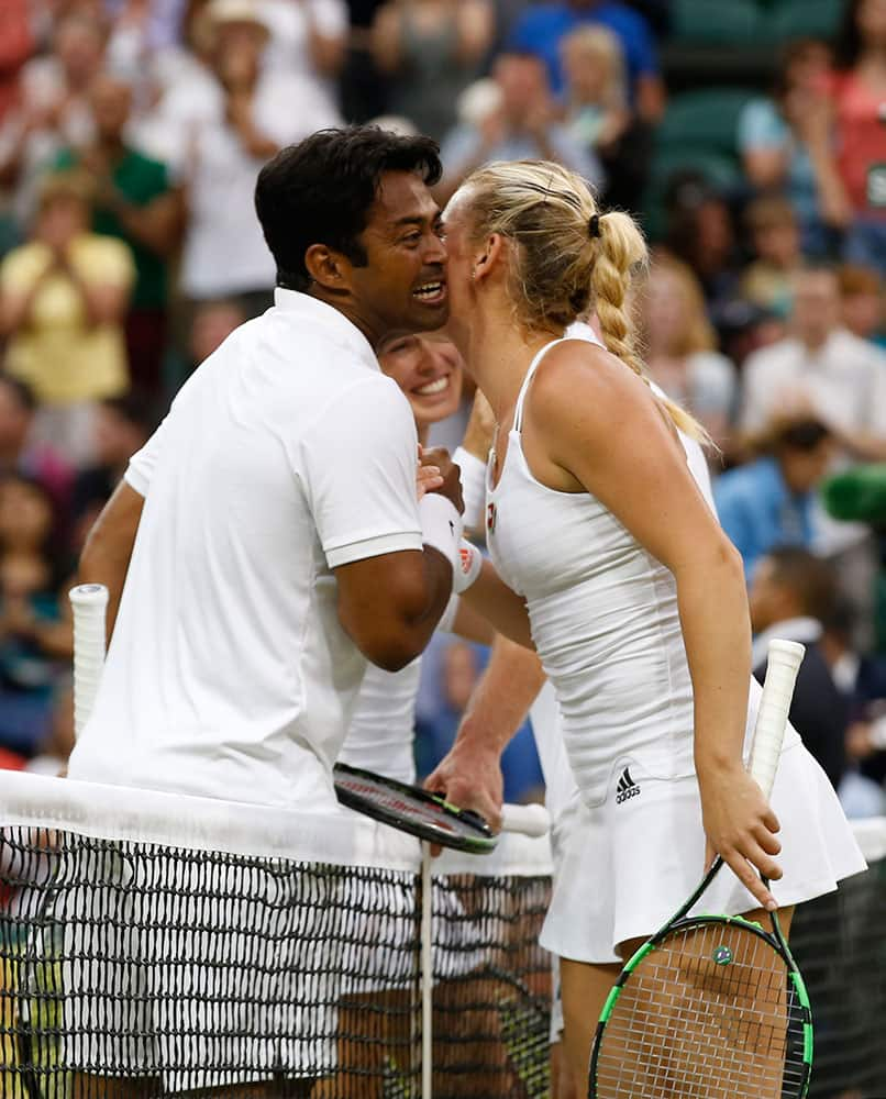 Leander Paes of India, left, and Martina Hingis of Switzerland celebrate winning the mixed doubles final against Alexander Peya of Austria and Timea Babos, right, of Hungary at the All England Lawn Tennis Championships in Wimbledon, London.