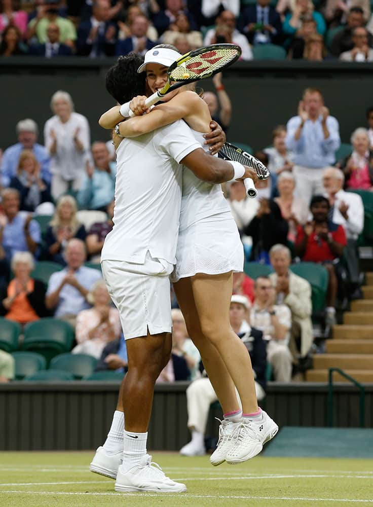 Leander Paes of India, left, and Martina Hingis of Switzerland celebrate winning the mixed doubles final against Alexander Peya of Austria and Timea Babos of Hungary at the All England Lawn Tennis Championships in Wimbledon, London.