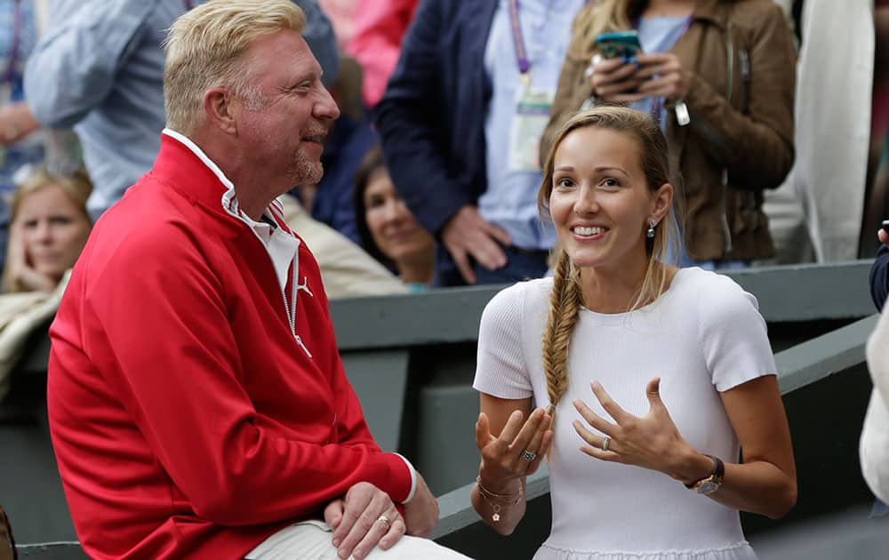 Jelena, wife of Novak Djokovic of Serbia, and his coach Boris Becker, celebrate after Djokovic won the men's singles final against Roger Federer of Switzerland at the All England Lawn Tennis Championships in Wimbledon, London.