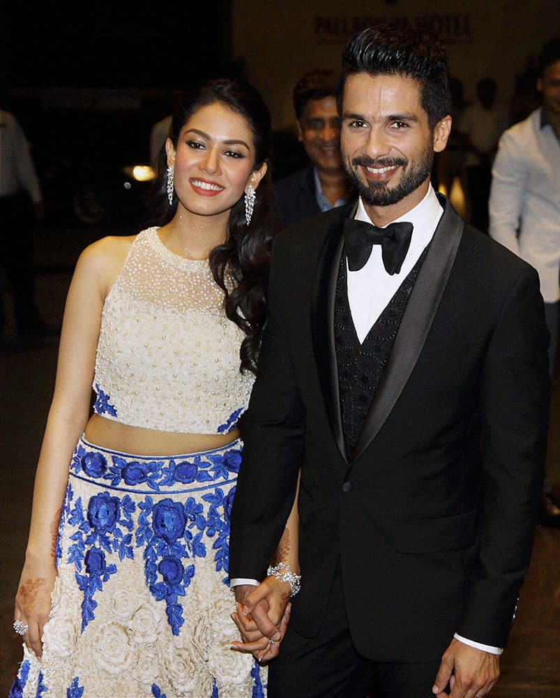 Bollywood actor Shahid Kapoor with his wife Mira Rajput during their wedding reception in Mumbai.