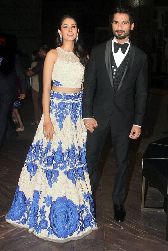 Bollywood actor Shahid Kapoor with his wife Mira Rajput during their wedding reception in Mumbai.