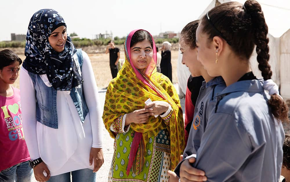 Nobel Peace Prize winner Malala Yousafzai, center, speaks with Syrian refugee girls during her visit to Bekaa Valley, east Lebanon. Malala celebrates her 18th birthday in Lebanon with Syrian refugees. 