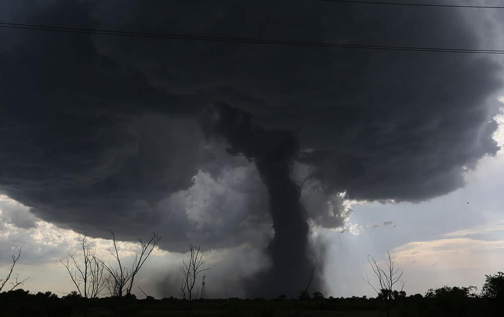 A tornado builds and travels southwest causing damage near Dean Rd. and 82nd Avenue in Hutchinson, Kan.