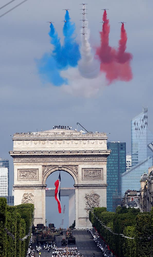 Jets for the Patrouille de France fly over the Arc de Triomphe during the traditional Bastille Day parade on the Champs-Elysees avenue in Paris, France.