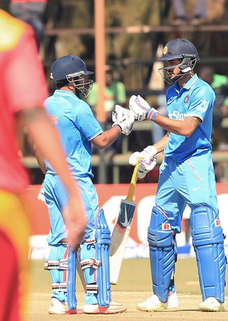 Manish Pandey and Kedar Jadhav touch gloves during the third One Day International cricket match against Zimbabwe in Harare, Zimbabwe.