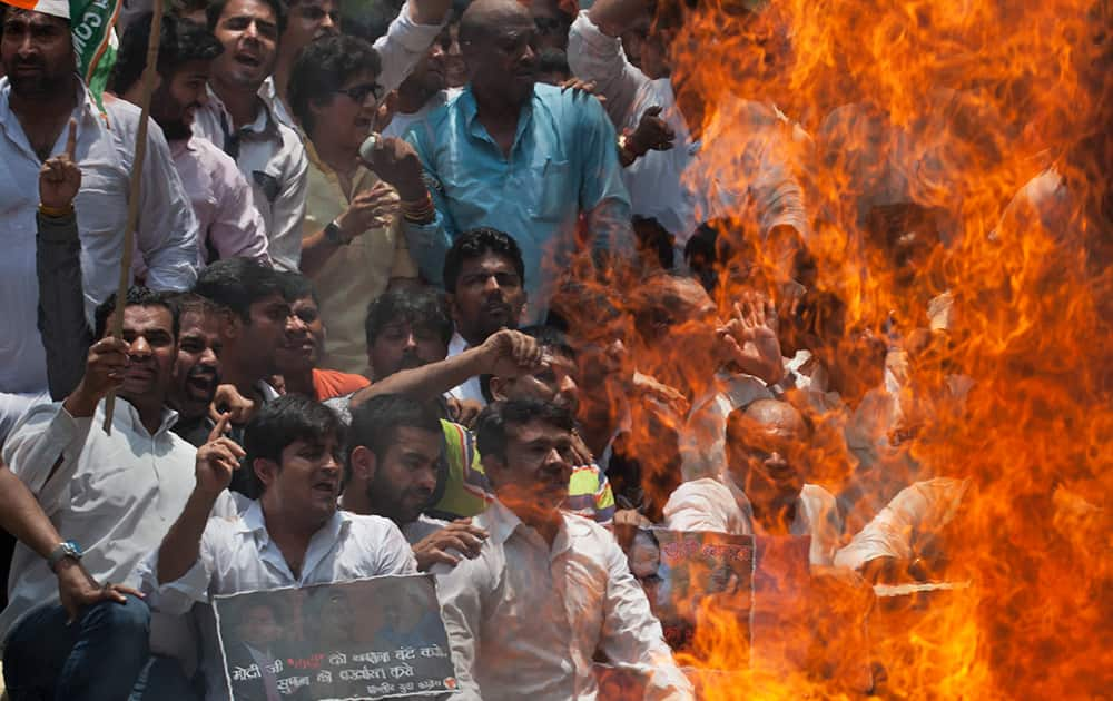 Activists of India's opposition Congress party's youth wing enact a mock Hindu funeral during a protest against a multimillion-dollar college admission and government job recruitment scandal in New Delhi.