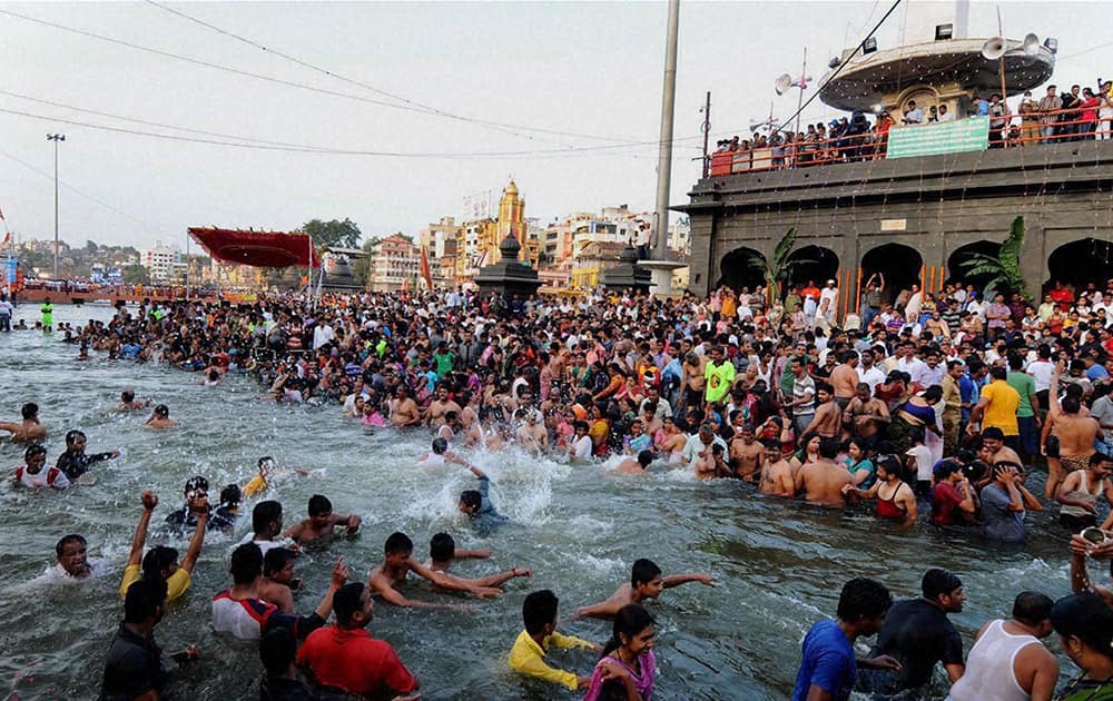 Devotees taking holy bath in Godavari River during the Simhastha Kumbha Mela in Nashik.