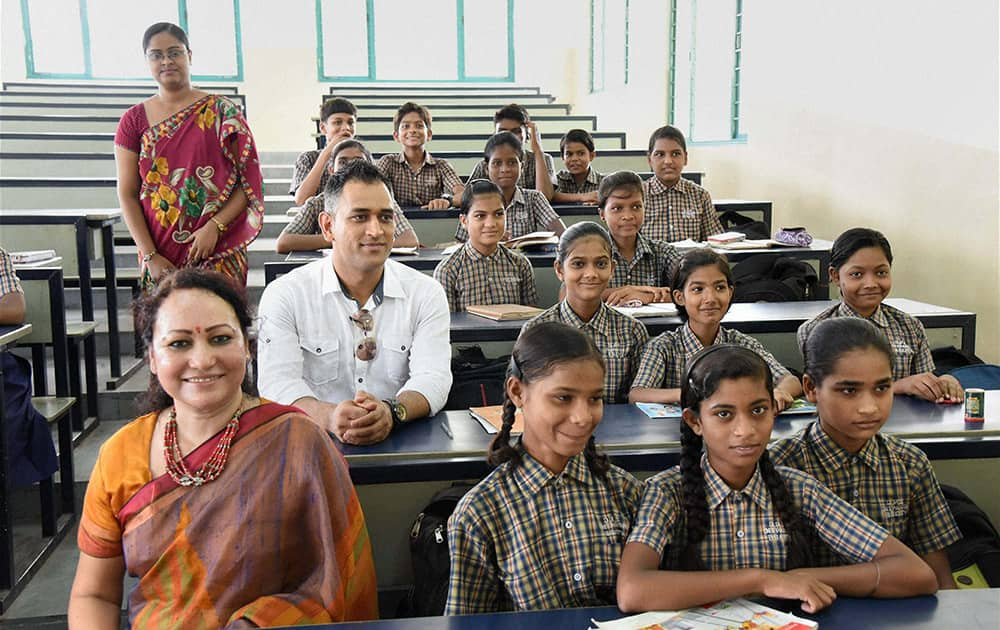 Mahendra Singh Dhoni along with the students during a program at a school in Bokaro, Jharkhand.