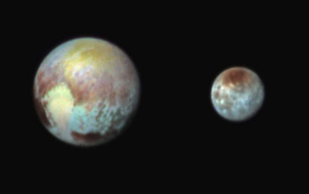 Pluto, left, and its moon, Charon, with differences in surface material and features depicted in exaggerated colors made by using different filters on a camera aboard the New Horizons spacecraft. In this composite false-color image, the apparent distance between the two bodies has also been reduced.