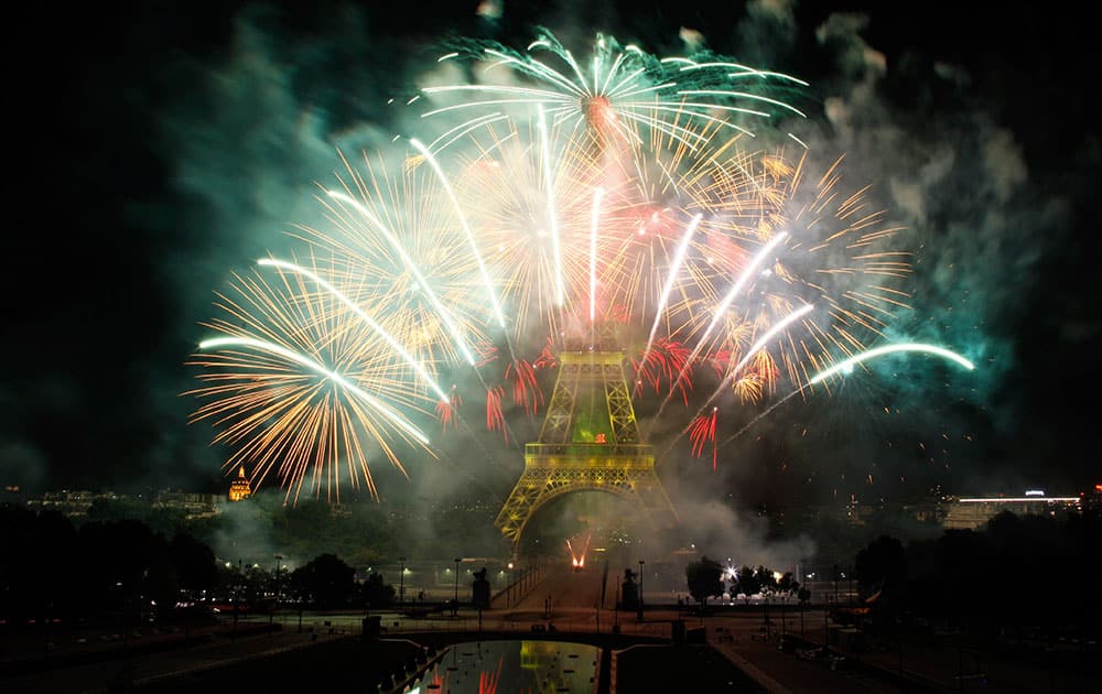 Fireworks illuminate the Eiffel Tower in Paris during Bastille Day celebrations.