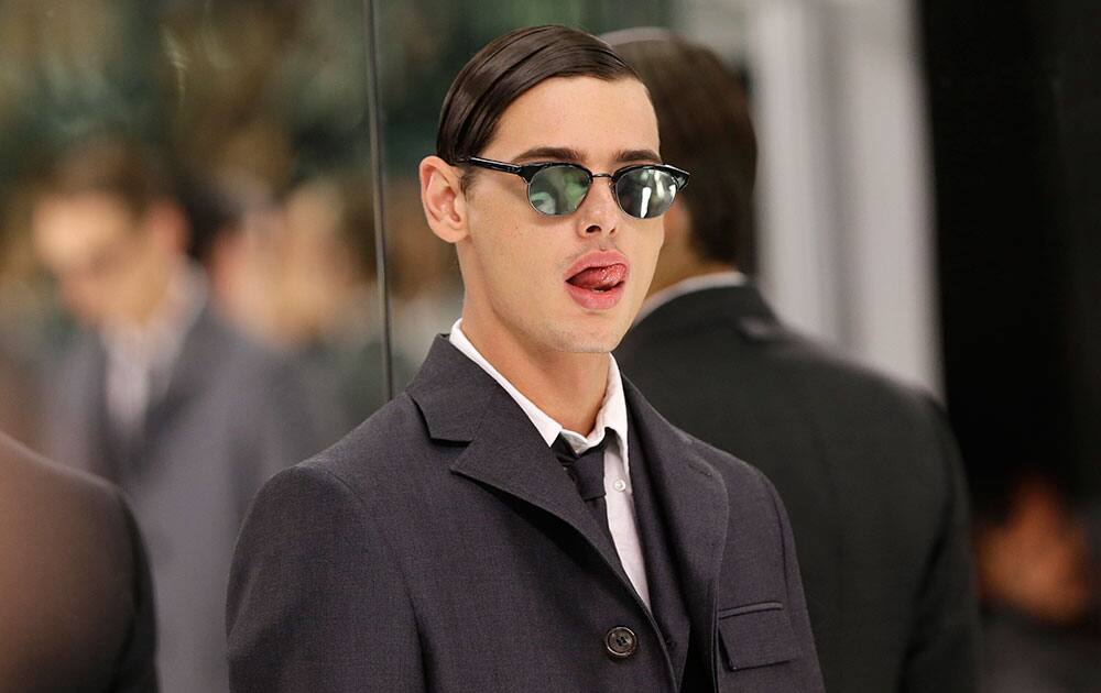 A model stands in a mirrored room during a presentation by Thom Browne at Men's Fashion Week in New York.