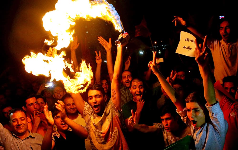 Iranians celebrate following a landmark nuclear deal in Tehran, Iran.