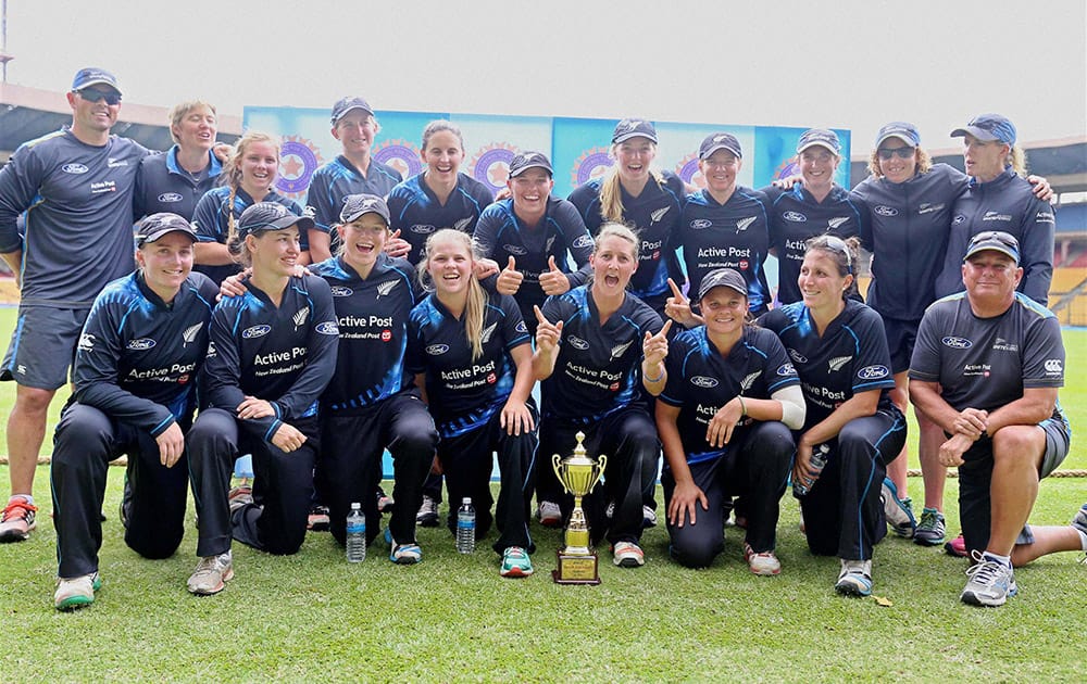 New Zealand women cricketers pose for a group photo with T20 trophy after winning the series against India by 2-1 at Chinnaswamy stadium in Bengaluru.