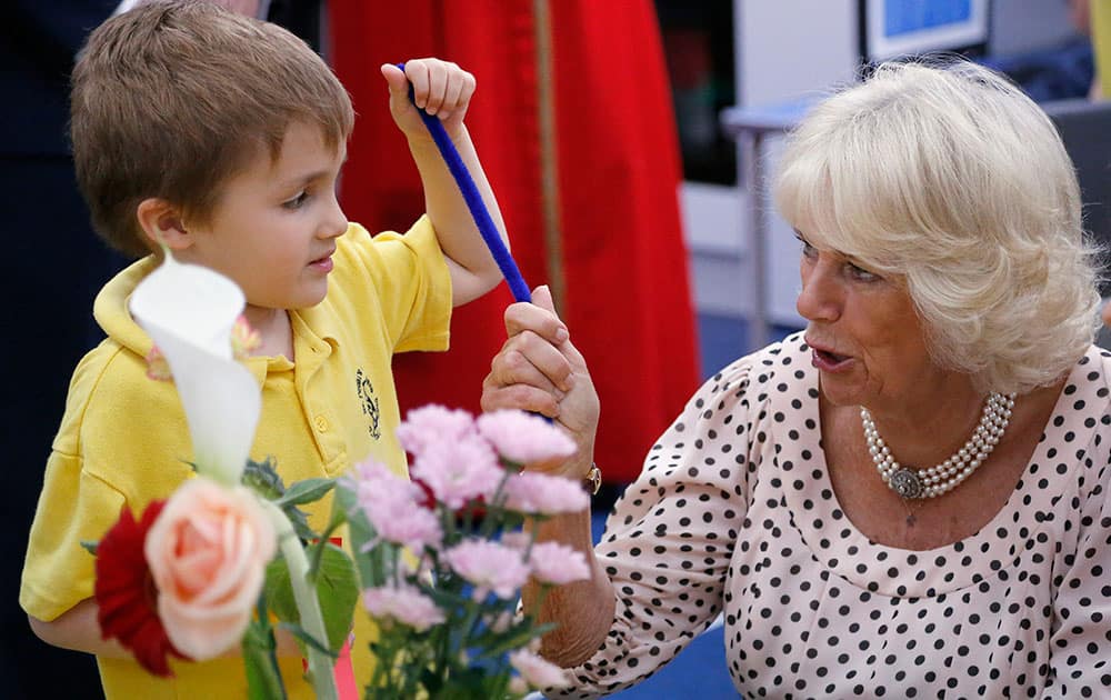 The Duchess of Cornwall talks to a pupil as she visits St. Peter's Eaton Square Church of England Primary School in London.