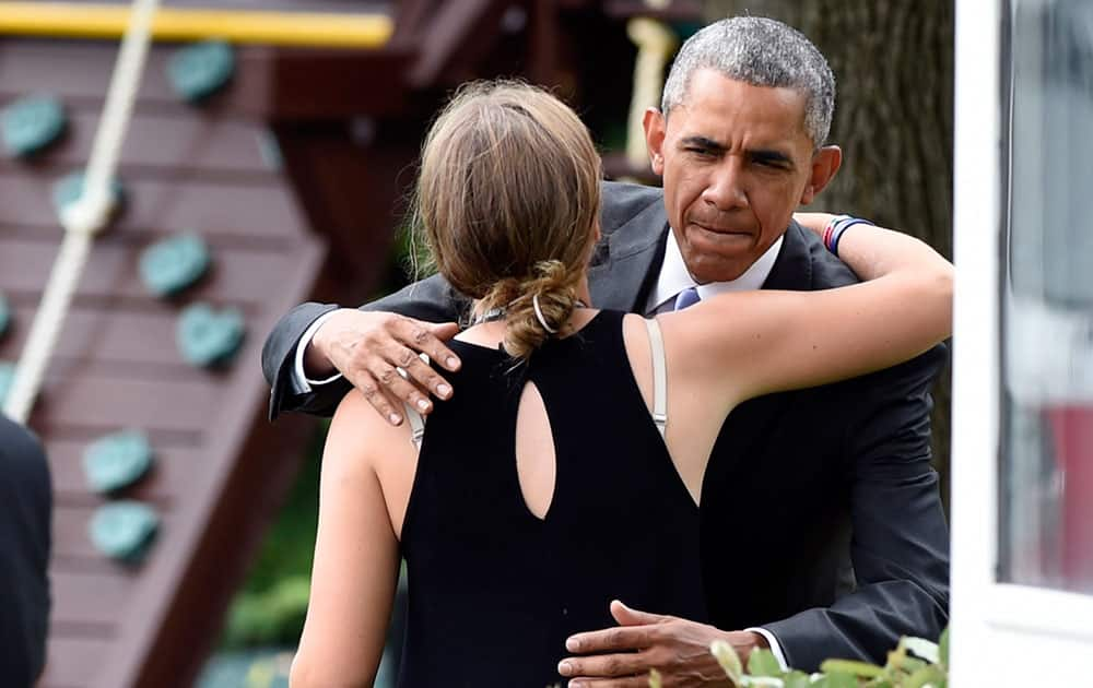 President Barack Obama stops to hug Finnegan Biden, granddaughter of Vice President Joe Biden, on the South Lawn of the White House in Washington.