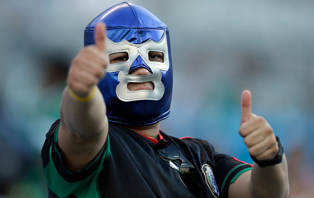 A Mexico fan cheers before a CONCACAF Gold Cup soccer match against Trinidad & Tobago in Charlotte, N.C.