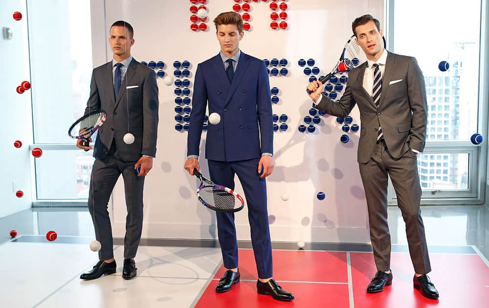 Models bounce tennis balls and hold racquets during the Tommy Hilfiger presentation at Men's Fashion Week in New York.