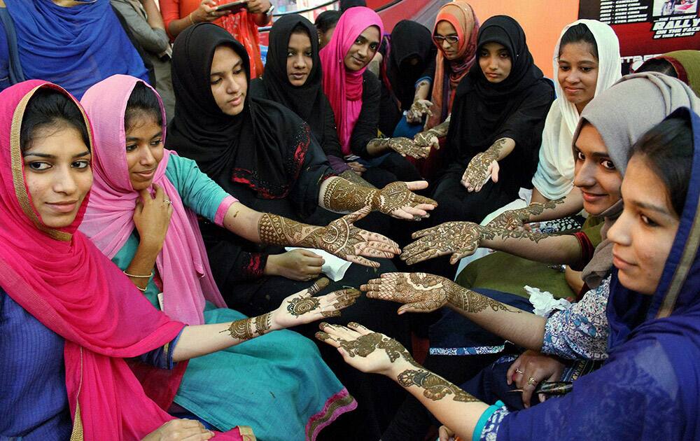 Girls show Mehndi designs on their hands ahead of Eid-ul-Fitr in Kozhikode.