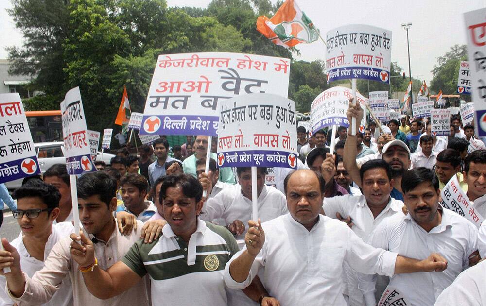 Youth Congress workers hold placards during a protest against AAP governments decision to increase VAT in New Delhi.