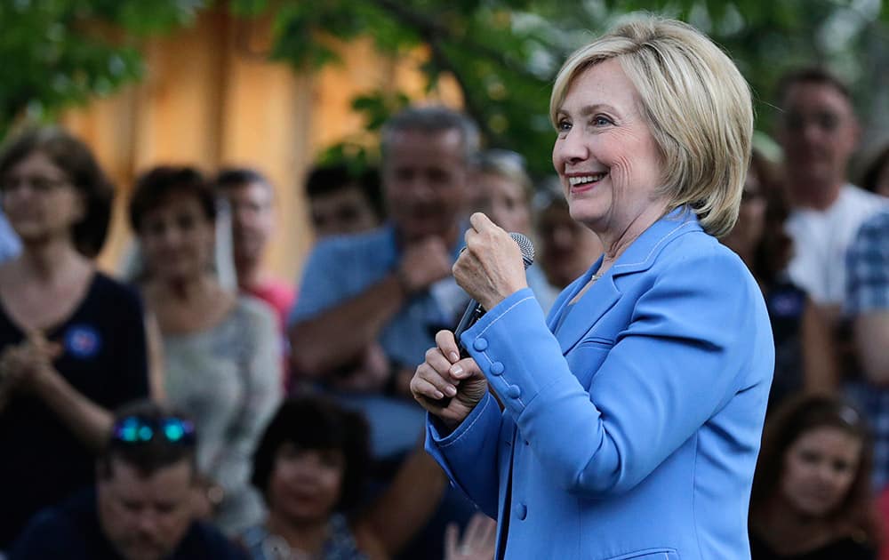 Democratic presidential candidate Hillary Rodham Clinton smiles as she listens to a question during a house party in Windham, N.H.