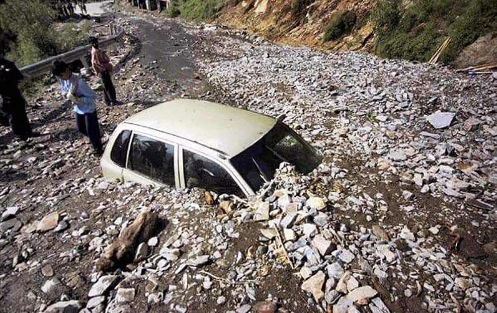 A car buried under debris after a cloudburst struck on the Srinagar-Leh road in Sonamarg area of Kashmir.