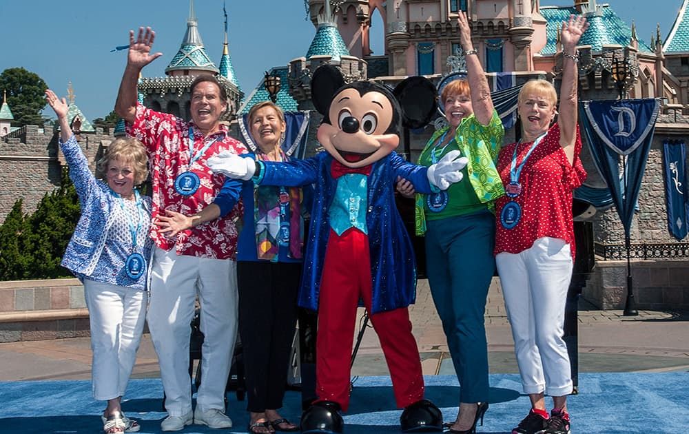 The original Mouseketeers have their photo taken with Mickey Mouse in front of Sleeping Beauty Castle during Disneyland's 60th birthday celebration in Anaheim, Calif.