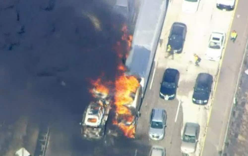 In this frame from video provided by NBC4, smoke rises from vehicles as a fast-moving wildfire swept across a freeway near Hesperia, Calif. The fire swept by desert winds burned on both sides of Interstate 15, the main connector between Southern California and Las Vegas that was crowded with vehicles.