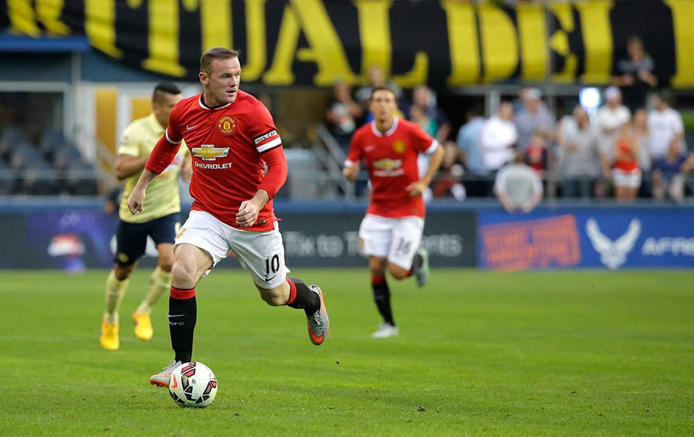 Manchester United's Wayne Rooney looks to pass against Club America during the first half of an international friendly soccer match in Seattle. 