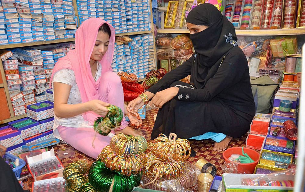 A Muslim woman purchasing bangles at a shop ahead of Eid-ul-Fitr festival in Mirzapur.