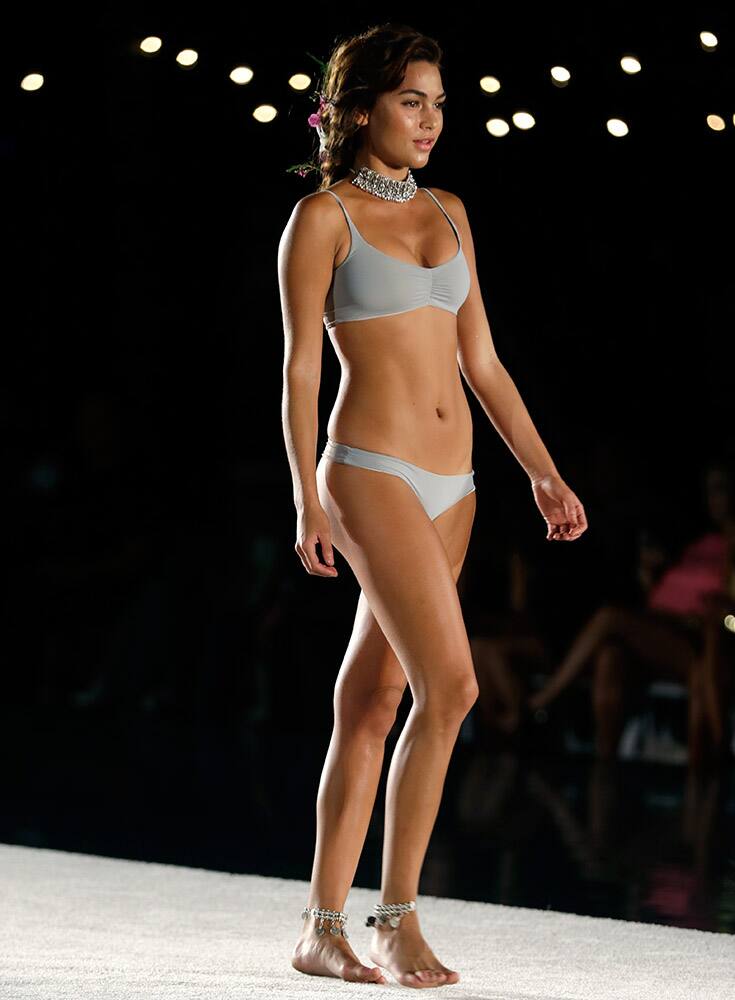 A model walks down the runway during the San Lorenzo Bikinis swimwear show as part of Funkshion Fashion Week Swim in Miami Beach, Fla.