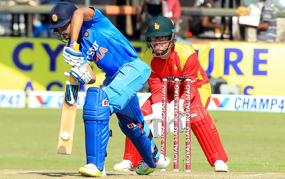 Manish Pandey blocks the ball as Zimbabwean wicketkeeper Charles Coventry looks on during the Twenty20 cricket match against Zimbabwe in Harare, Zimbabwe.