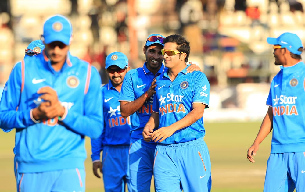 Indian cricket players walk off the pitch after winning the Twenty20 cricket match against Zimbabwe in Harare, Zimbabwe.