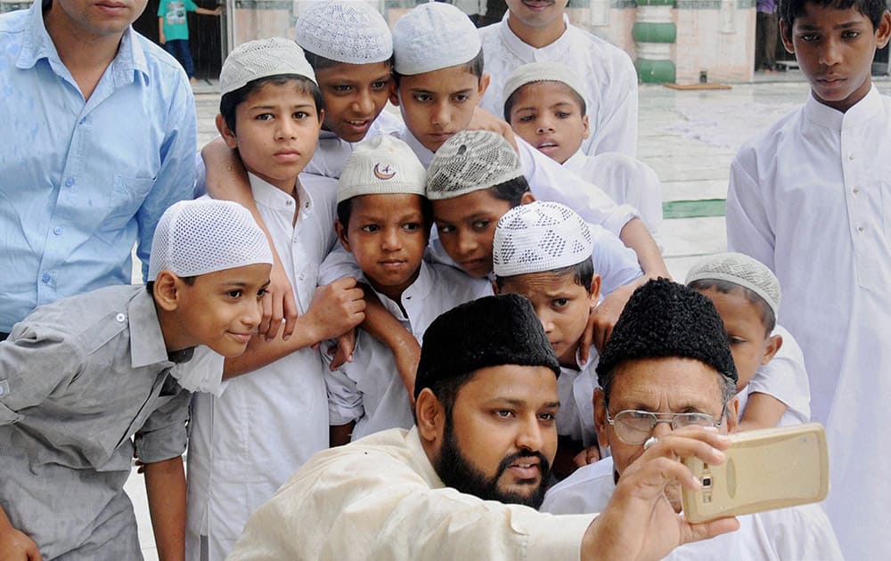 Muslims take selfie after offering prayers on the occasion of Eid-ul-Fitar festival at Jama Masjid in Amritsar.