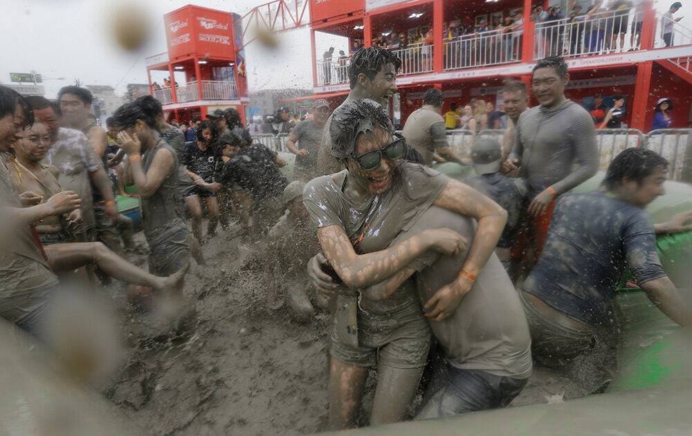 People play in a mud pool during the Boryeong Mud Festival at Daecheon Beach in Boryeong, South Korea.