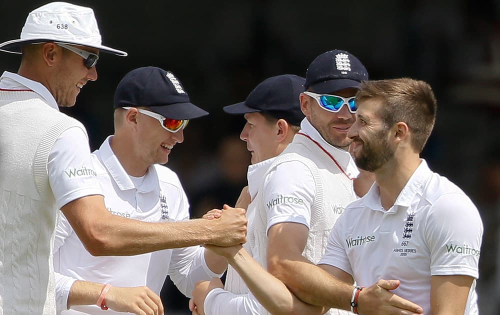 England's Mark Wood celebrates taking the wicket of Australia's Michael Clarke on the second day of the second Ashes Test match between England and Australia, at Lord's cricket ground in London.