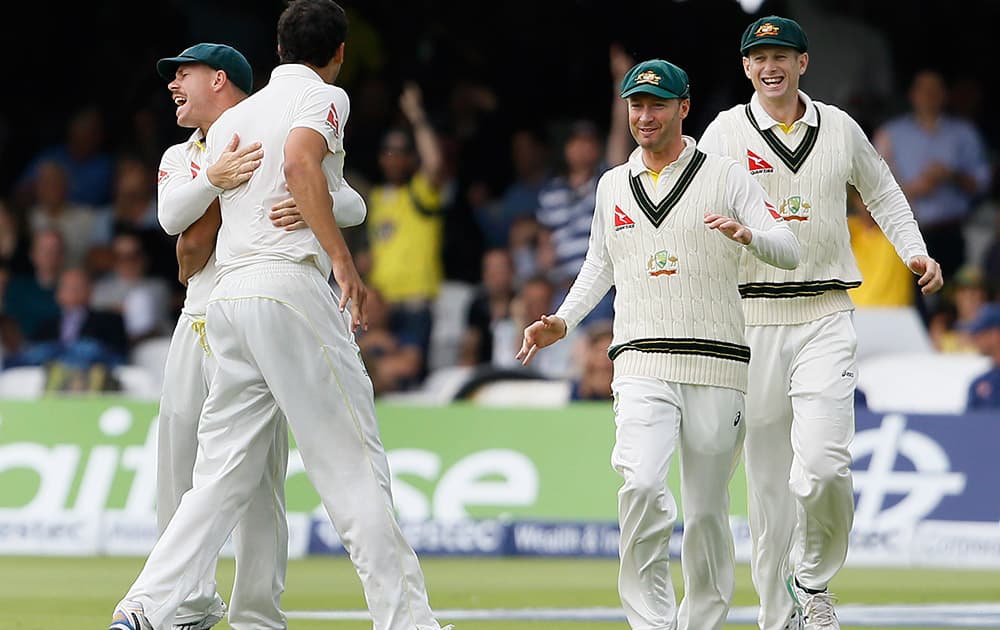 Australia's players celebrate taking the wicket of England's Adam Lyth on the second day of the second Ashes Test match between England and Australia, at Lord's cricket ground in London.