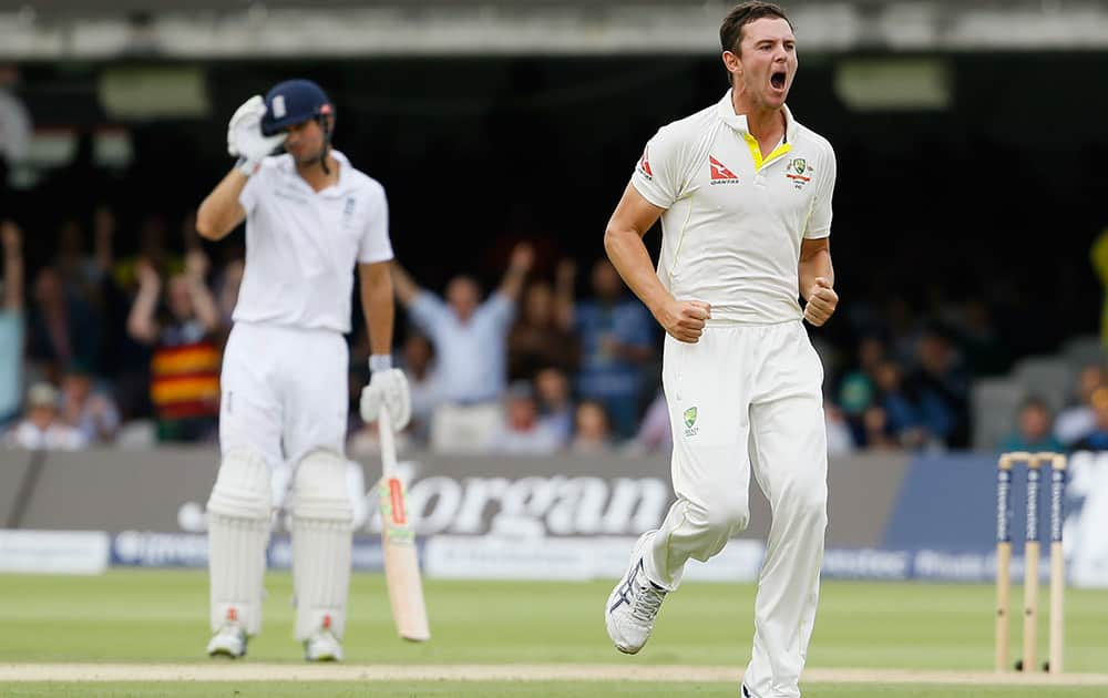 Australia's Josh Hazlewood runs past Alastair Cook to celebrate taking the wicket of England's Ian Bell on the second day of the second Ashes Test match between England and Australia, at Lord's cricket ground in London.