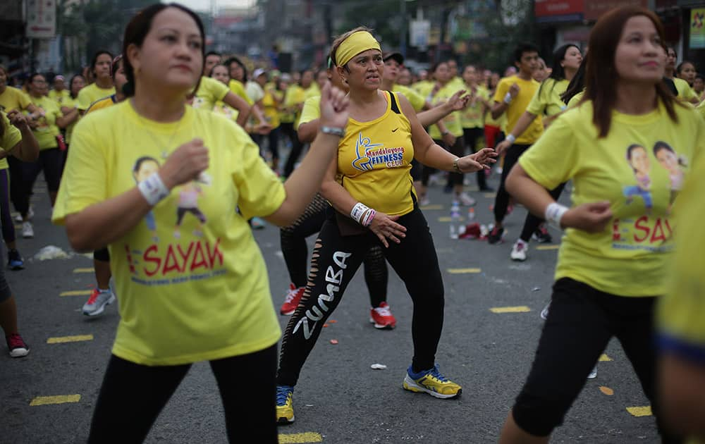 A Filipino woman joins a Zumba class as they attempt to break a Guinness world record in suburban Mandaluyong, east of Manila, Philippine.