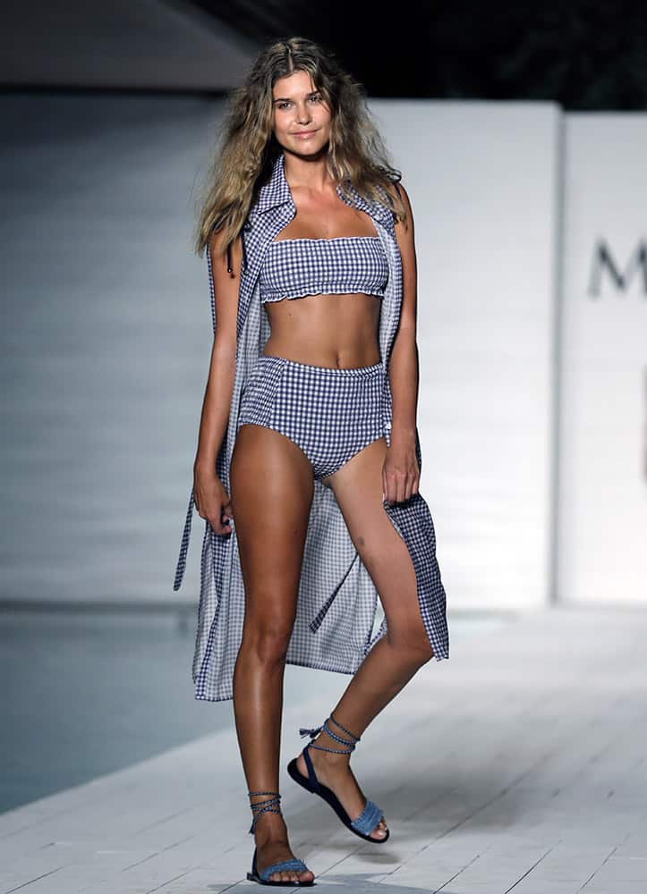 A model walks down the runway during the Maxim Swimwear collection launch as part of Funkshion Fashion Week Swim in Miami Beach.