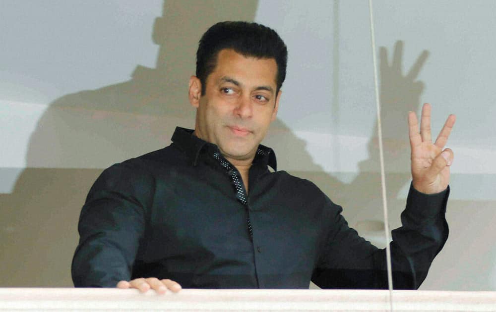 Salman Khan waves his fans during Eid al-Fitr celebrations in Mumbai.