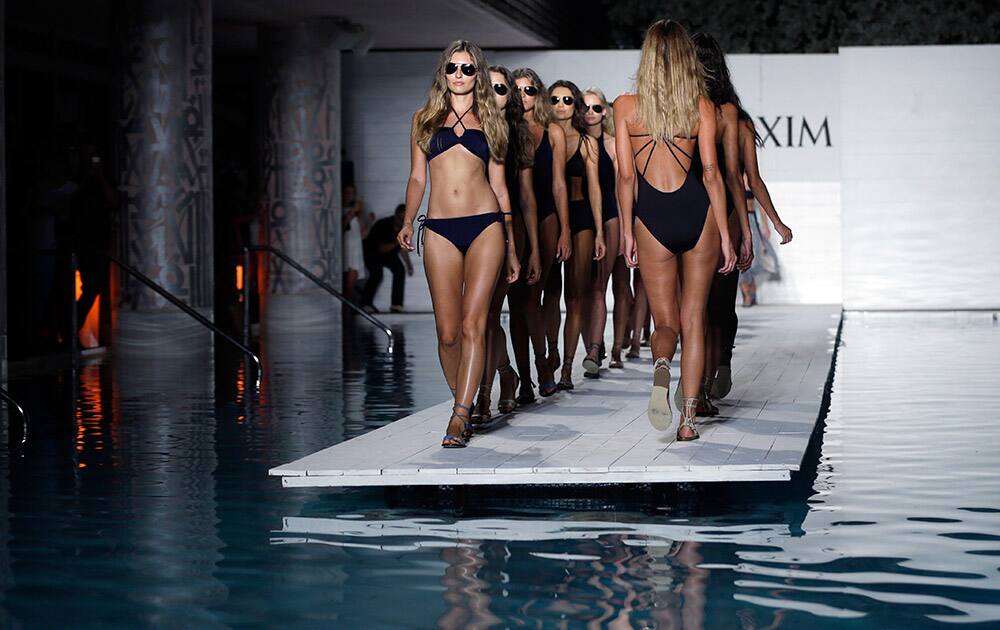 Models walk down the runway during the Maxim Swimwear collection launch as part of Funkshion Fashion Week Swim in Miami Beach, Fla.